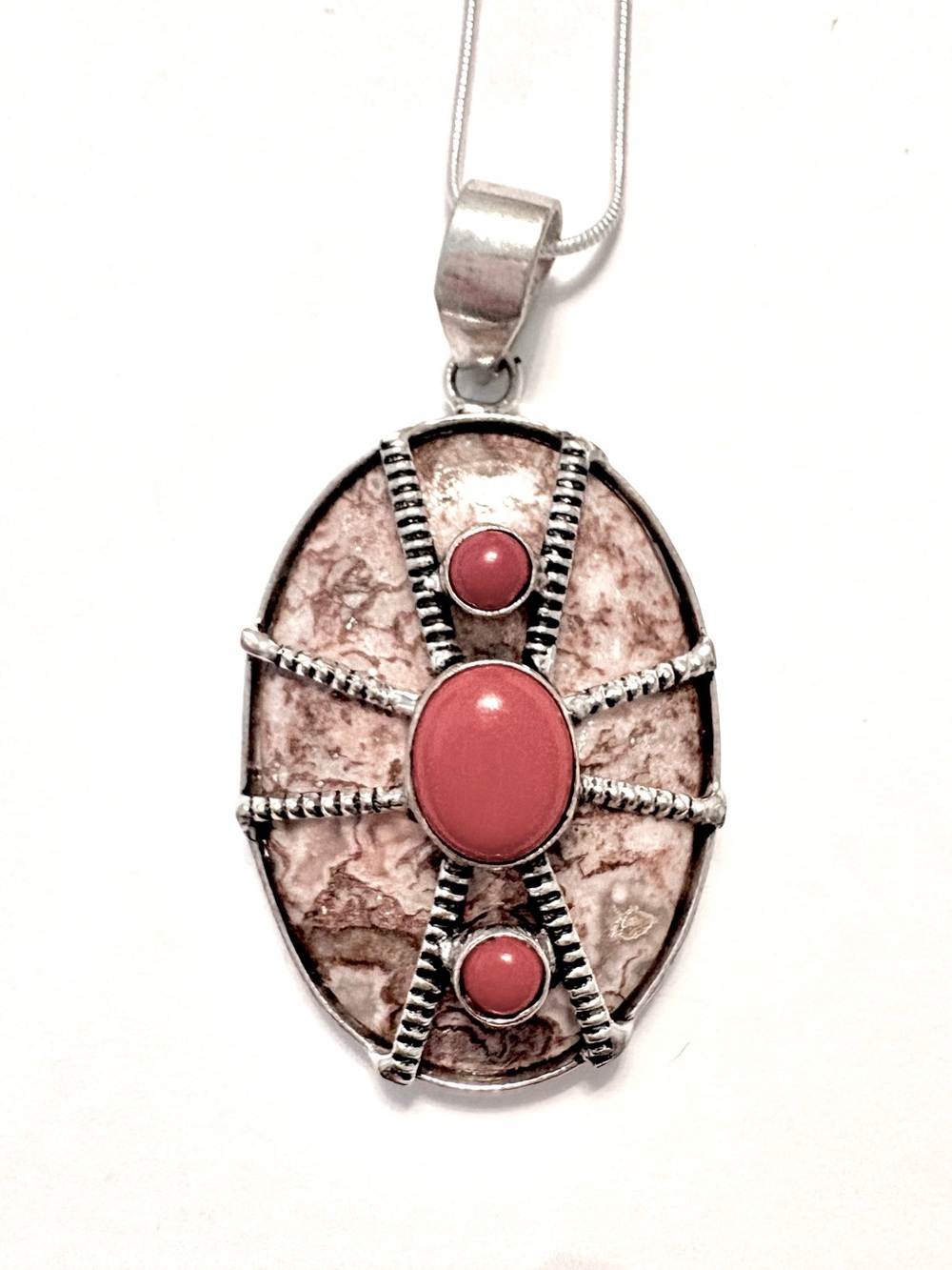 handcrafted 2 1/2  inch, Crazy Lase Agate, with  Coral draped over the front